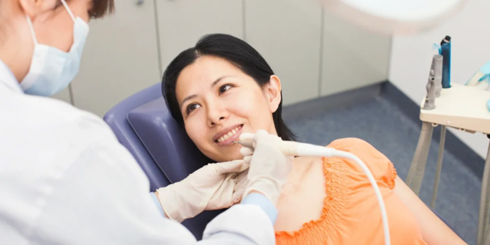 Dentist cleaning teeth