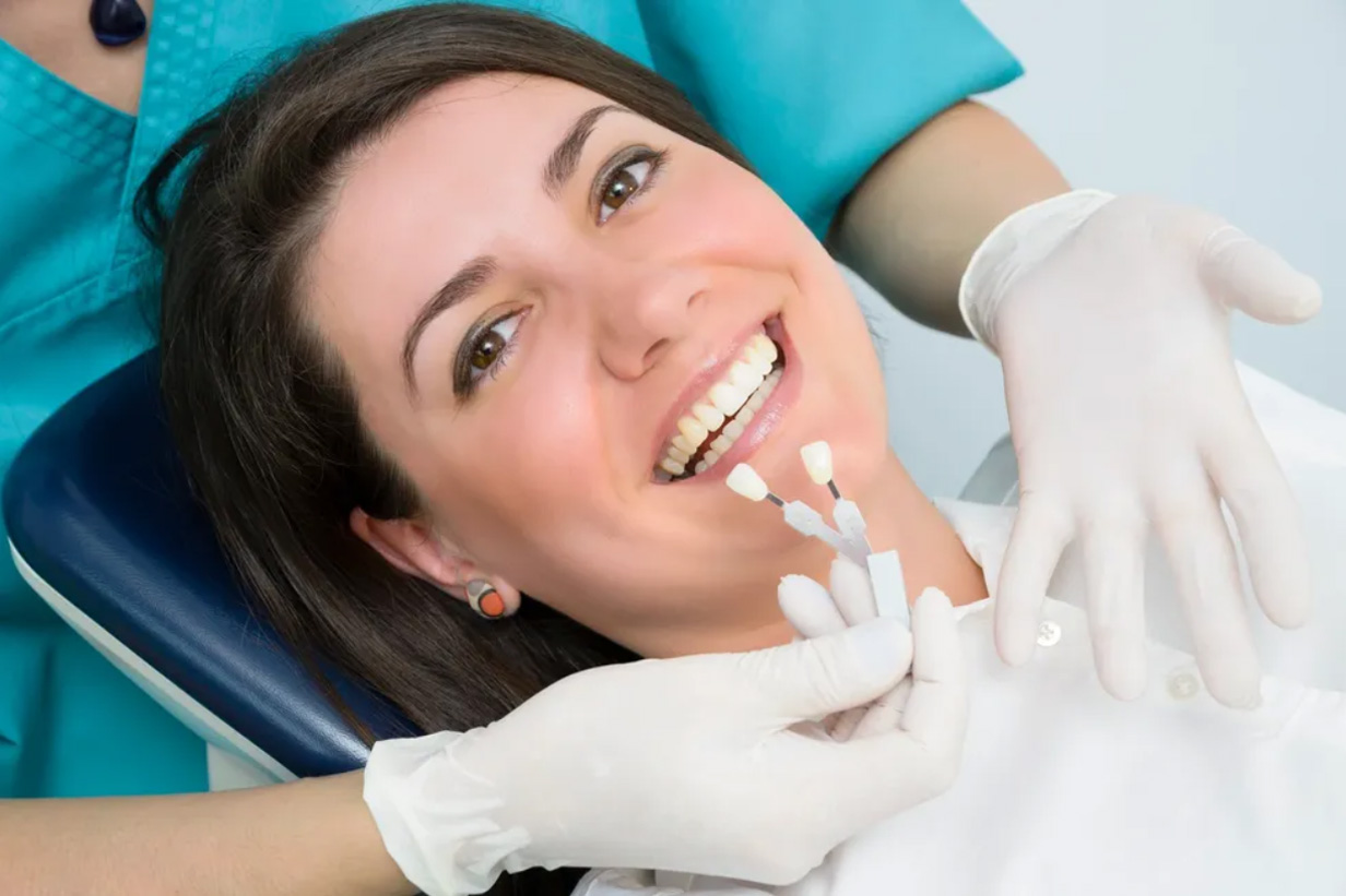 Dentist matching filling color during filling procedure
